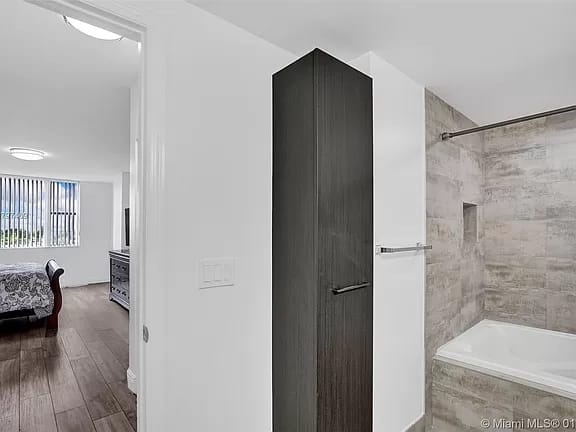 Renovated bathroom with a tiled shower and built-in storage