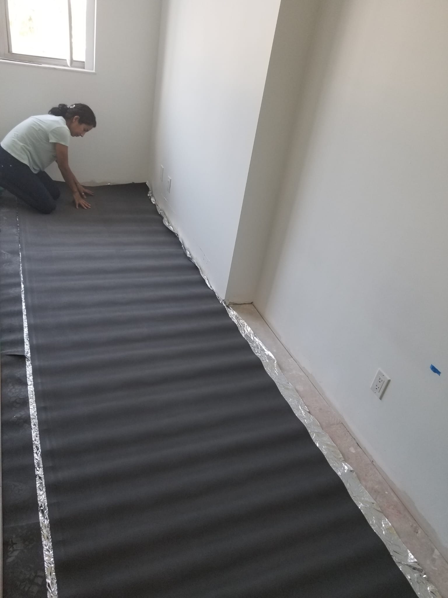 Flooring underlayment installation in progress