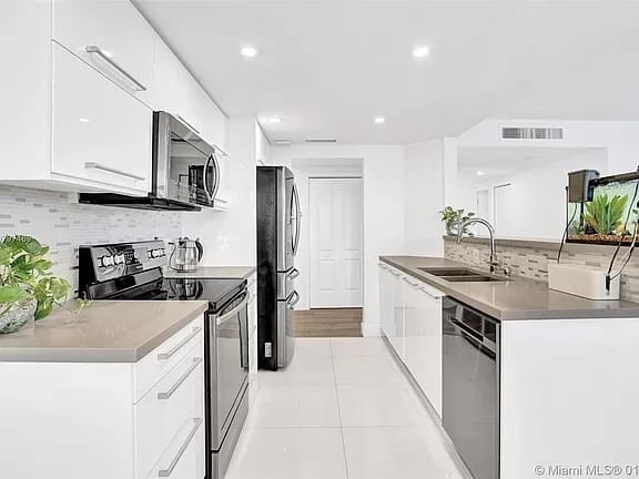 Galley kitchen renovation with an island and recessed lighting