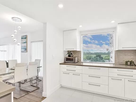 White kitchen renovation opening into the dining area