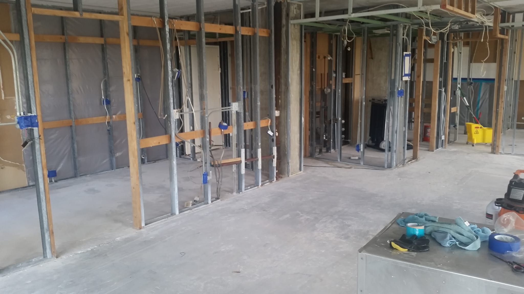 Open-plan renovation with wall framing and electrical rough-in
